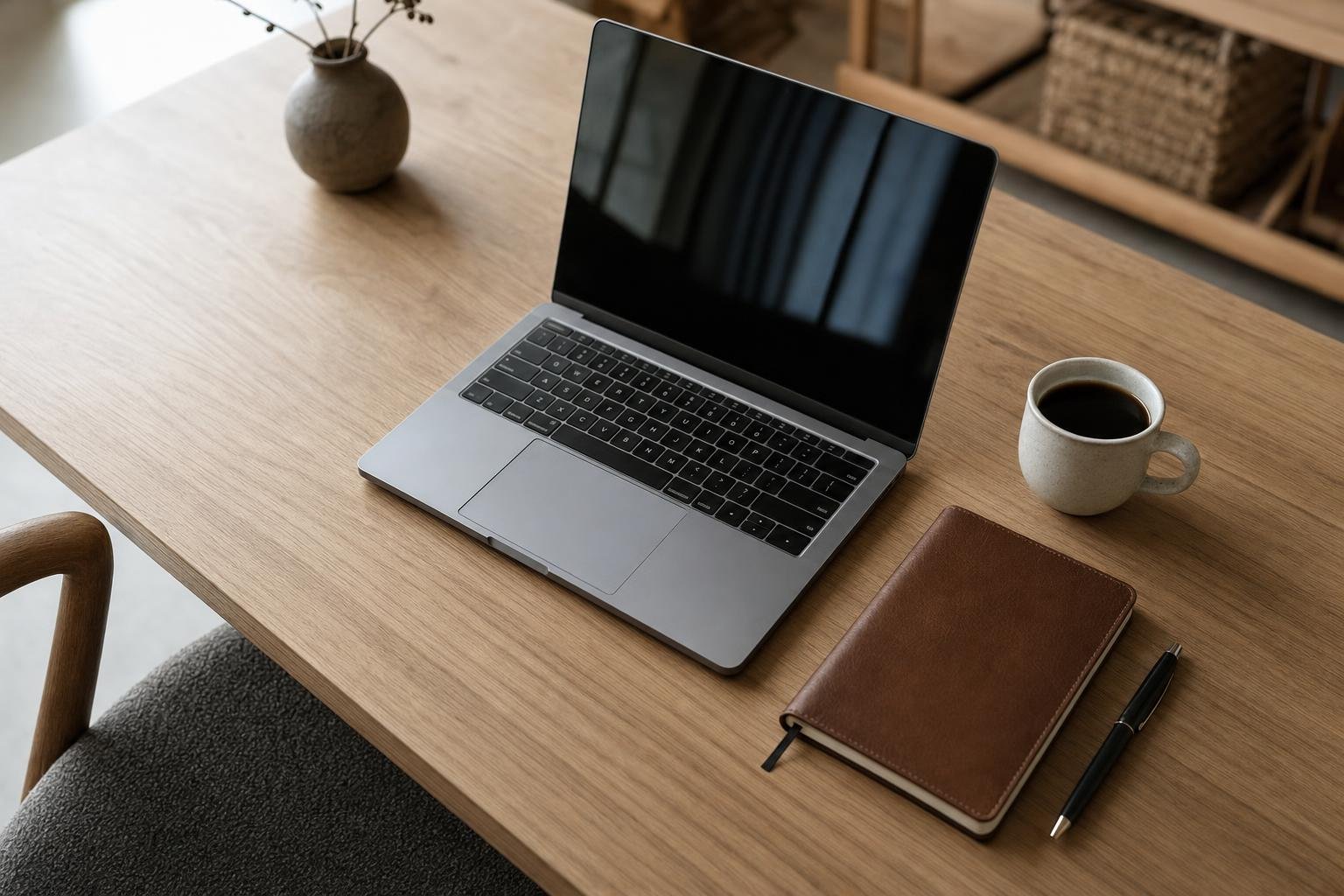 Tidy home-office desk with laptop and notebook